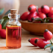 Load image into Gallery viewer, bottle-of-rose-hip-seed-oil-with-fresh-rosehips
